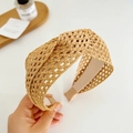 Detailed view of khaki braided knot headband with straw-like texture on white background - Khaki