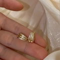 Macro detail of gold-plated triple-row pavé hoop earrings with sparkling zircons - Gold Three-Layer Zircon Ear Cuff
