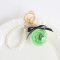 Green preserved rose keychain with pearl strap and gold metal clasp in a clear sphere - Green