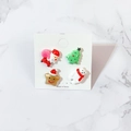 Close-up of four acrylic Christmas studs featuring Santa, tree, star, and polar bear - Santa Tree Star Polar Bear Set