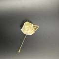 Detail of handmade cream satin rose lapel pin with a gold leaf on a long suit needle - Lotus Pink
