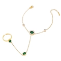 Elegant gold hand chain featuring green oval gemstones and a matching butterfly ring design - Green Zirconia Style