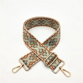 Close-up of ethnic geometric pattern strap with golden metal hooks and adjustable buckle - S10 Brown Edge Green