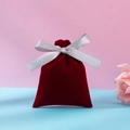 Wine red velvet gift bag with silver ribbon bow on a blue and pink backdrop - Burgundy-grey Ribbon; 10*12