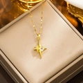Collana dorata con ciondolo a stella e zircone esposta in una scatola per gioielli beige - Stella a quattro punte (312) / Oro