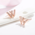 Elegant rose gold letter W stud earrings with sparkling zircon accents on white ceramic - Letter W Style / Rose Gold