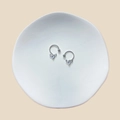 Detail of silver heart nipple rings with wings on a ceramic plate, stainless steel jewelry - Winged Heart Pendant (23071925)