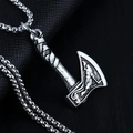 Silver axe pendant necklace with wolf relief and box chain on black leather background - Axe + Steel Chain