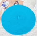 Flat lay of a sky blue wool beret hat on white lace background with a lifestyle touch - 52-54cm / Deep Lake Blue