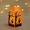Close-up of Halloween lantern with warm orange glow and spooky silhouette patterns - Scarecrow