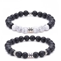 Detail of Pisces set with black volcanic lava stones, white turquoise and silver charms - Pisces