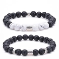 Close-up of Aquarius zodiac bracelet set with white turquoise and black lava stone beads - Aquarius