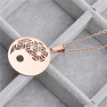 Detailed macro view of a rose gold Bagua pendant featuring Flower of Life geometric cutouts - Rose Gold Stainless Steel Chain