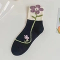 Navy blue crew socks with a purple floral knit pattern and white contrasting cuff - Black