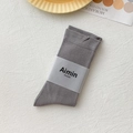 Grey Morandi style cotton mid-calf socks with paper band on soft textured background - One Size / Smoke