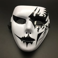 Macro shot of a white full-face Halloween mask with black tribal flame patterns and straps - Grim Reaper Style Black