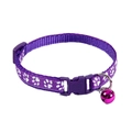 Detail of purple nylon pet collar featuring white paw prints and a small metal bell - Purple