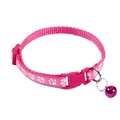 Close-up of pink nylon pet collar with white paw prints and a matching bell - Rose Red