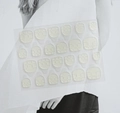 Macro detail of transparent double-sided nail adhesive tabs with 24 pieces for press-on nails - Yellow Glue (Lightly Waterproof)