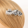 Macro detail of antique silver Halloween hair clip with skull, bat and skeleton hand - Skull Alien / Silver Skull