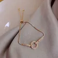 Macro detail of adjustable gold bracelet with zircon geometric charms on silk fabric - 7# 18K Gold Geometric Circle Slider