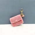 Detail of pink sherpa mini coin purse with gold clasp and elegant tassel charm - Pink