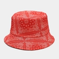 Close-up of red bucket hat featuring white paisley bandana print and soft textile texture - M / Red