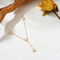 Detail of gold Y-necklace with white shell butterfly pendants and clover style charms - Gold White Shell Necklace