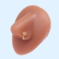 Detail of gold planet nose stud with pink zircon and star charm on a display model - Gold Planet Pink Zirconia (#18)