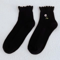 Schwarze Baumwollsocken für Damen mit Blumenstickerei und gewelltem Rollrand-Abschluss - Schwarz