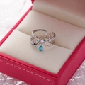 Close-up of silver flower ring with micro-pave crystals and blue teardrop gem in a red box - 6#14117B (Silver Blue Water Drop Pendant)