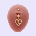 Golden heart-shaped belly button ring with crystals on a model with purple background - Heart Zirconia Inlay