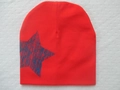 Bright red knitted baby beanie featuring a distressed blue star print on the side - Blue Pentagram / Red