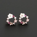 Floral hoop earrings with pearl shells and butterfly detail on a black background - Rose Gold