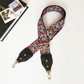 Detail view of floral print bag strap with black leather ends and golden hardware - Small Floral Black Leather
