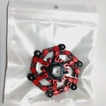 Mechanical fidget spinner toy with red and black chains in clear zip-lock packaging - Red