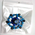 Close-up of a blue and black mechanical finger fidget spinner toy in clear polybag - Blue