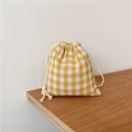 Close-up of yellow plaid linen drawstring bag on a rustic wooden table surface - 14x16cm / Yellow Plaid Small