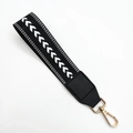 Woven black wristlet strap with white herringbone pattern and gold metal clasp - Black