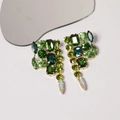 Luxurious green crystal teardrop fringe earrings with gold-tone setting on a white background - Green