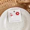 Detail shot of asymmetric Christmas snowman and snowflake earrings on white card - A Snowman + Snowflake