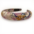 Detail shot of the woven bohemian floral headband with a black Hand Made interior label - Pink Beige and Blue Satin-like Floral