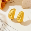Macro detail of gold earrings featuring spiral texture and brushed metal finish - Chrysalis Style (23991)