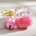Close-up of pink lucky cat keychain with internal glitter and matching metal bell - Lucky Cat Quicksand + Bell / Pink