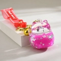 Detail of pink lucky cat liquid sand keychain with stars and golden bell accessory - Rose Red