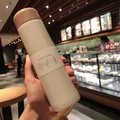 Mini 150ml wood-grain lid vacuum flask in creamy white matte finish held in a cafe - 150ML / White