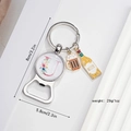 Close-up of beer bottle opener keychain with floral letter J and enamel beer charms - Letter U