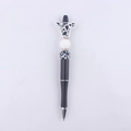 Detail of DIY beaded pen featuring a cute cow silicone topper and black and white beads - Black