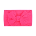 Pink soft nylon baby headband featuring a large bow on a minimalist white background - Bright Pink (094)