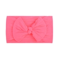 Detail of soft pink nylon headband with a large fabric bow for babies on white background - Rose Red (019)